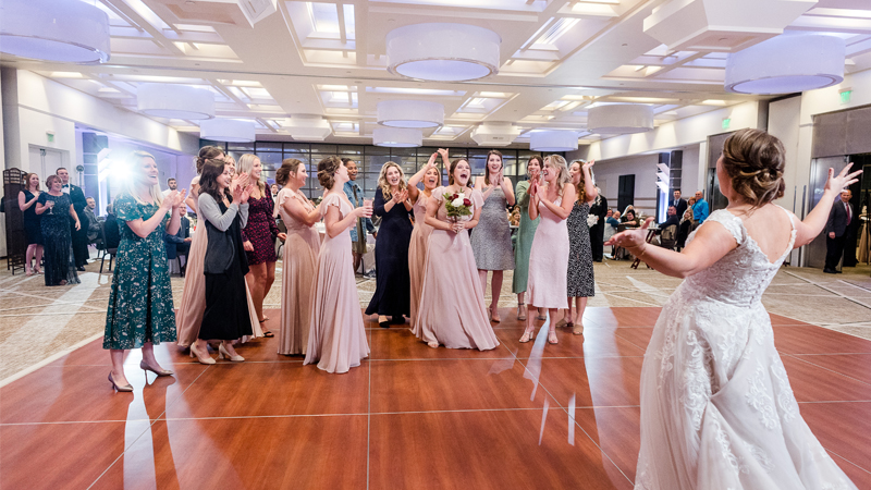 Bride throwing bouquet in Big Ten Rooms