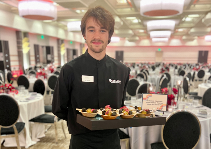 Kellogg Center team member holding a tray of appetizers